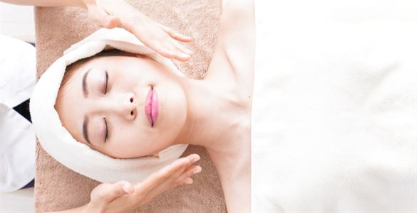 two hands hovering above a woman's face