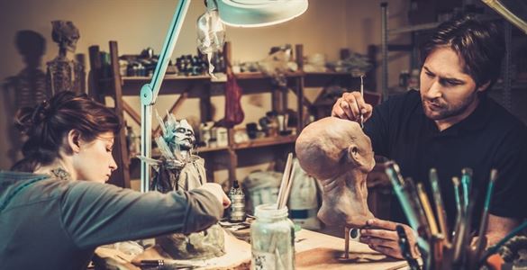 two people painting figures